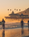 Silhouette of a surfer at Malibu's Surfrider Beach at dawn.