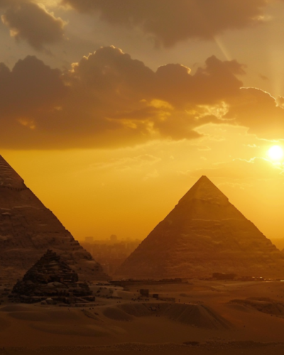 Pyramids set against the setting sun in Cairo, Egypt