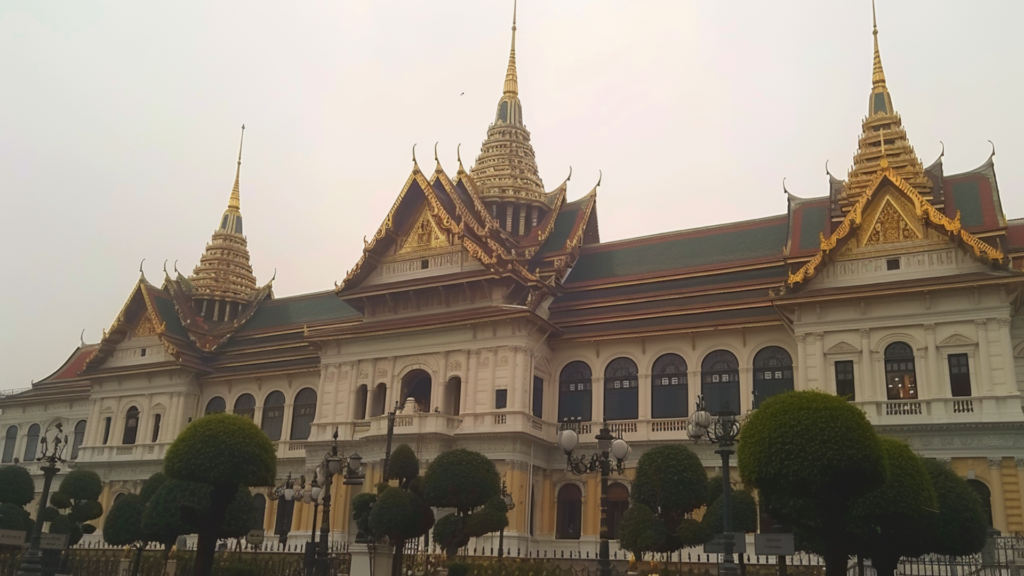 The Grand Palace in Bangkok with trees in the foreground