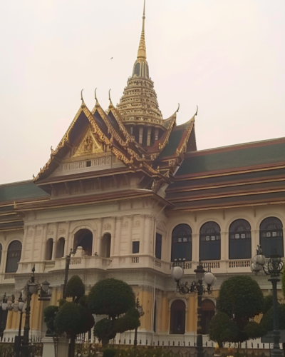 The Grand Palace in Bangkok with trees in the foreground