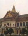 The Grand Palace in Bangkok with trees in the foreground