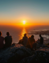 Sunrise from Table Mountain with tourists and panoramic views of Cape Town and the ocean.