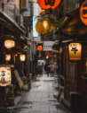A narrow, stone-paved alley lined with traditional izakaya in Osaka, Japan