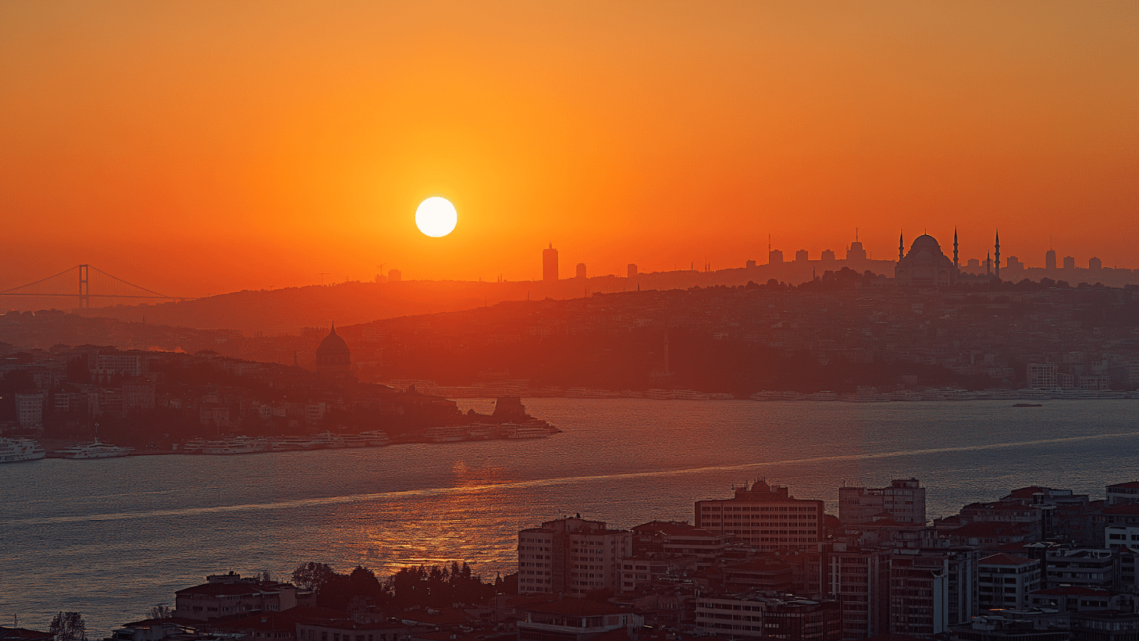 The sun setting over the Bosphorus, casting a golden glow over the city, epitomizing the melding of history and modernity in Istanbul
