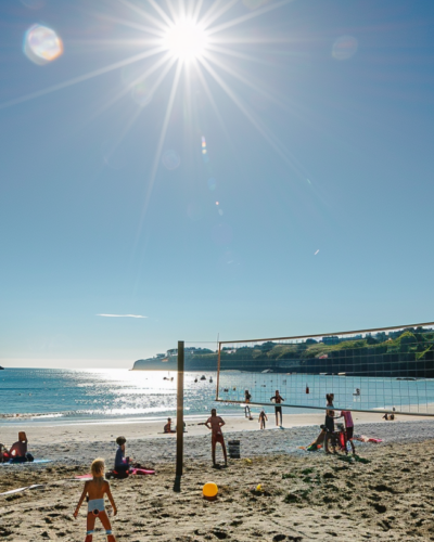 A beach volleyball game with cheering spectators on a sunny day in Dunmore Town.